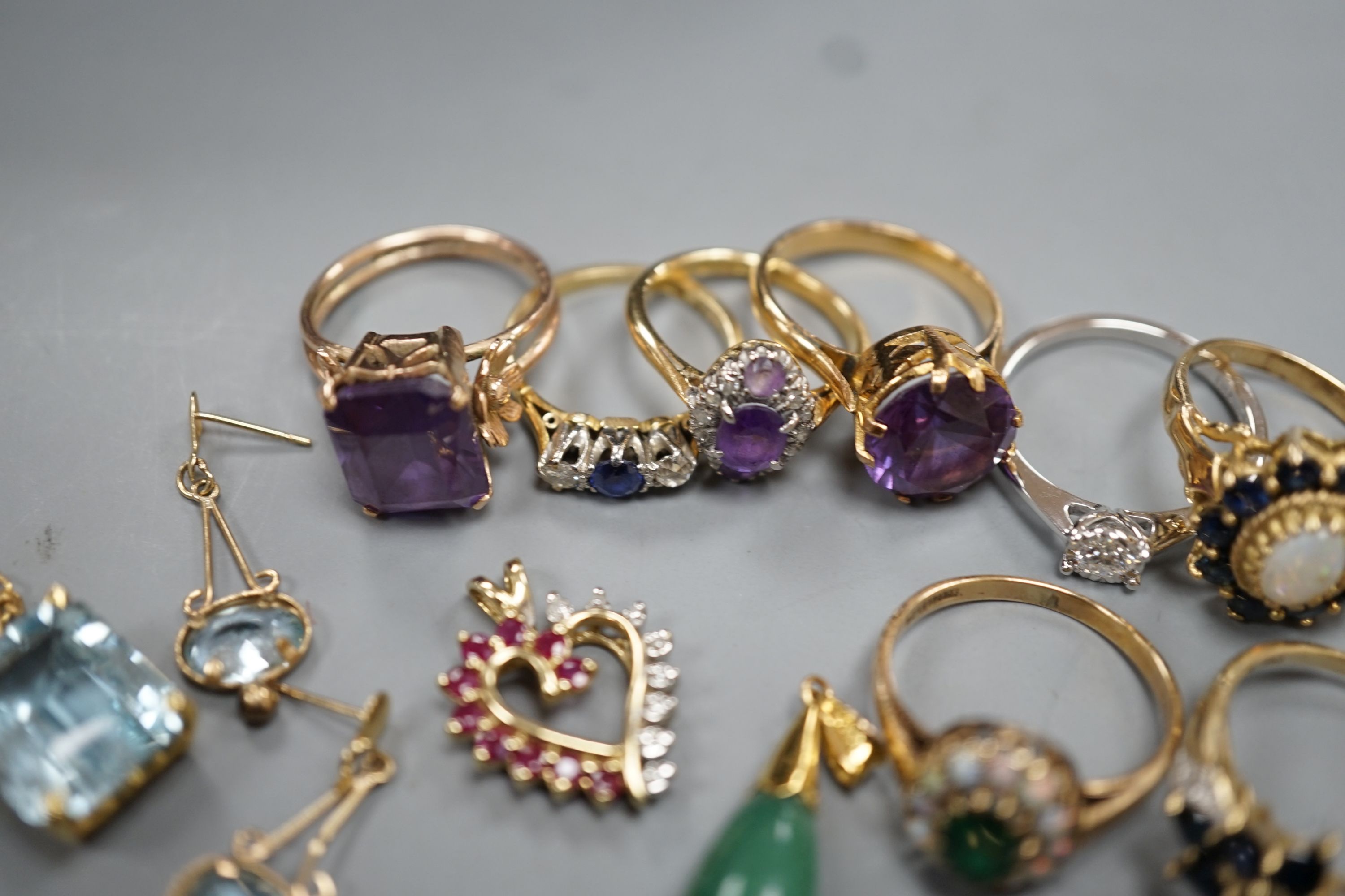 Two 18ct and gem set rings, including amethyst and diamond, size K and sapphire and diamond three stone, size J/K, gross 5.5 grams, four 9ct and gem set rings and two 9ct and gem set pendants, gross 19.9 grams, two yello